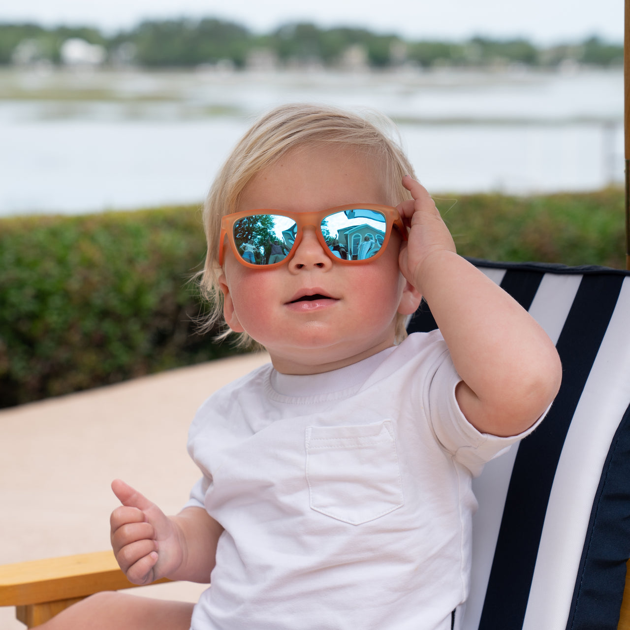 Little boy wearing orange polarized kids sunglasses by sunnies shades