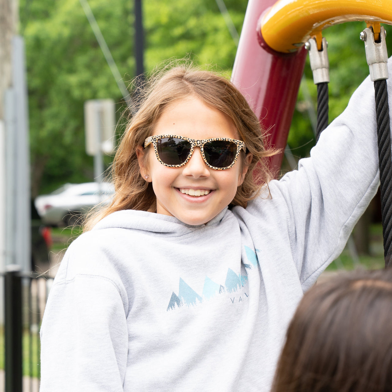 Girl wearing polarized leopard print kids sunglasses by Sunnies Shades