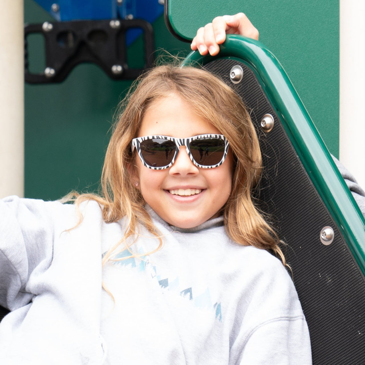 young girl wearing zebra print kids sunglasses with polarized lenses and 100% uva/uvb protection